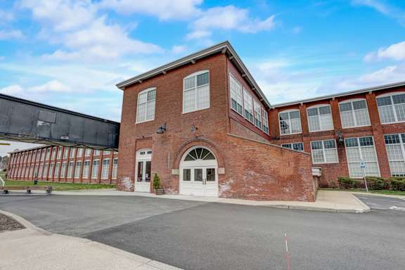 the facade of a red brick building with a white door