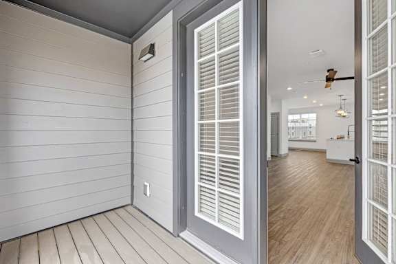 the view of a hallway from a home with white walls and doors at Meridian at CityPlace in Woodbury, MN 55125