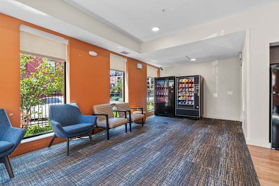 A room with orange walls and a vending machine.