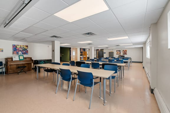 a dining room with tables and chairs in a classroom