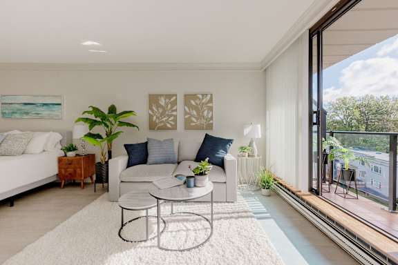a living room with a couch and a coffee table and a large window