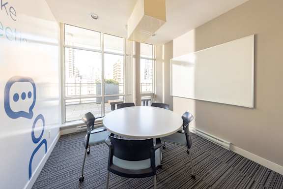 a conference room with a white table and chairs