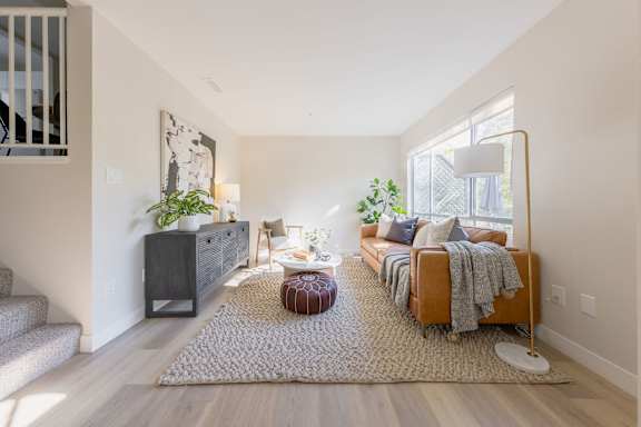a living room with a couch and a rug