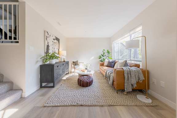 a living room with a couch and a rug