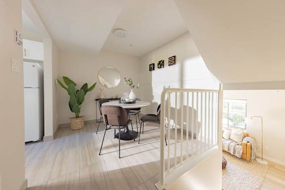 a dining room with a table and chairs and a white crib