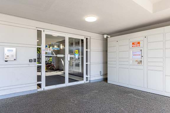 the interior of a garage with glass doors and white walls