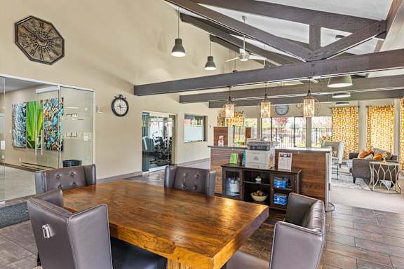 A conference room with a long table and chairs.