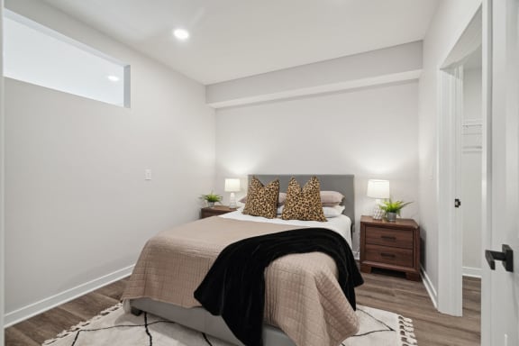 a bedroom with white walls and a bed with pillows