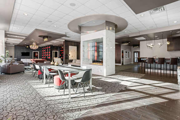 A modern dining room with a circular table and chairs.