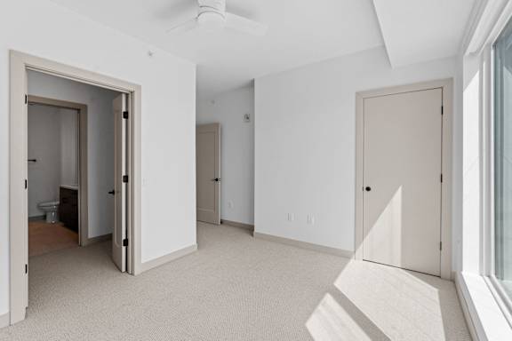 a living room with white walls and a door to a bedroom at The Mera, Minnesota