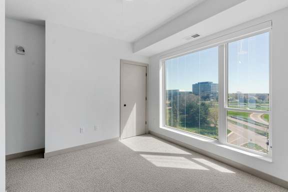 a living room with a large window and a door to the street at The Mera, Minnesota