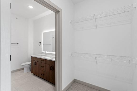 a bathroom with a toilet and a sink and a mirror at The Mera, Minnesota