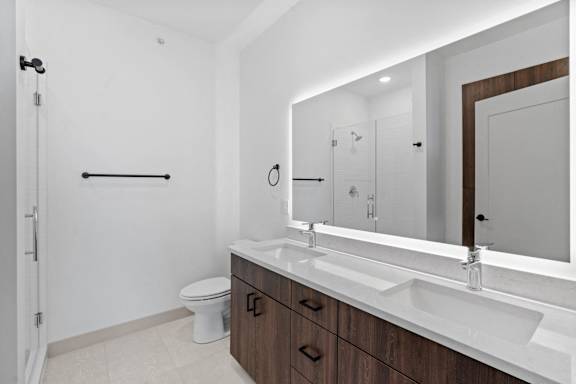 a bathroom with a large mirror and a sink and a toilet at The Mera, Minnesota