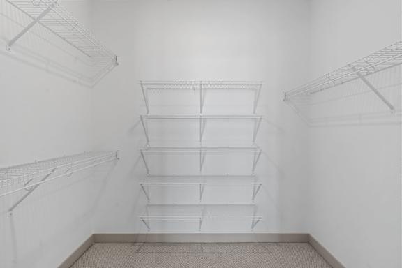 a white room with white shelving on the wall and a white ceiling and floor at The Mera, Minnesota, 55426