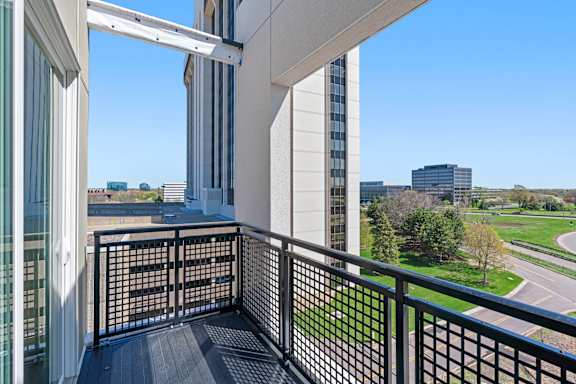 a balcony with a view of a building and a street at The Mera, St Louis Park, MN 55426