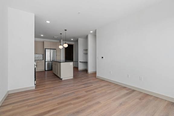 a living area with a kitchen and a hardwood floor at The Mera, St Louis Park Minnesota