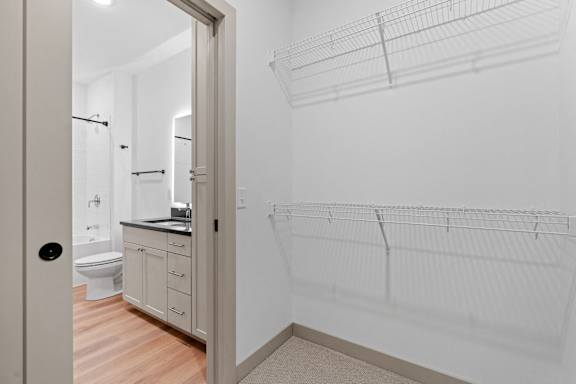 a bathroom with a shower and a sink and a mirror at The Mera, St Louis Park