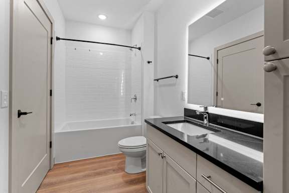 a bathroom with a sink and a toilet and a shower at The Mera, St Louis Park