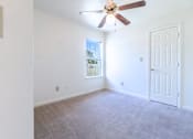 Thumbnail 5 of 8 - an empty living room with white walls and a ceiling fan at Huntington Village **, Georgia