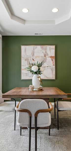 A dining room with a table set for four.