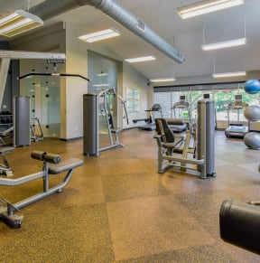 a gym with cardio equipment and glass doors at Riverset Apartments, Memphis, 38103
