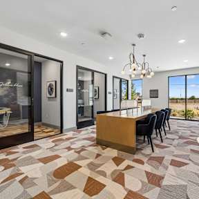 A modern kitchen with a tiled floor and a dining area.