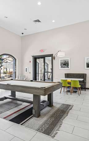 A bedroom with a bed, nightstand, and a mirror.