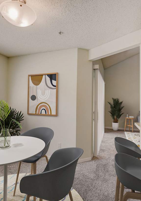 A dining room with a round table and chairs.