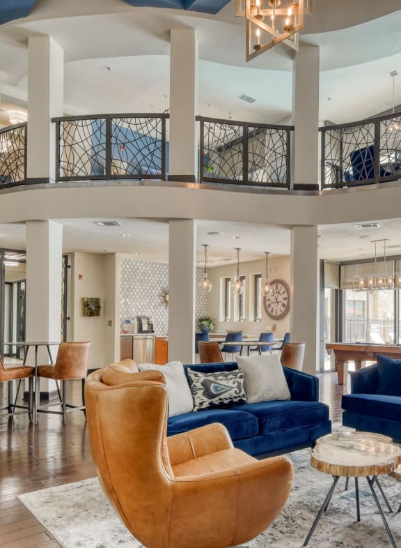 a living room with couches and chairs and a spiral staircase