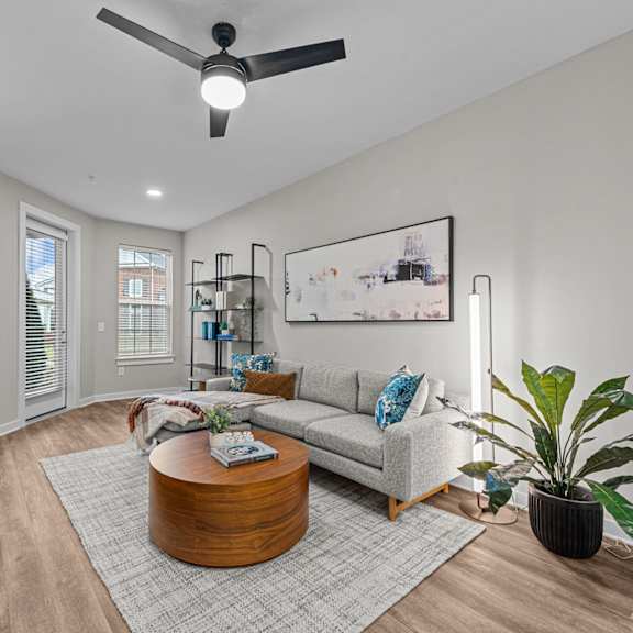 A living room with a grey couch and a coffee table.