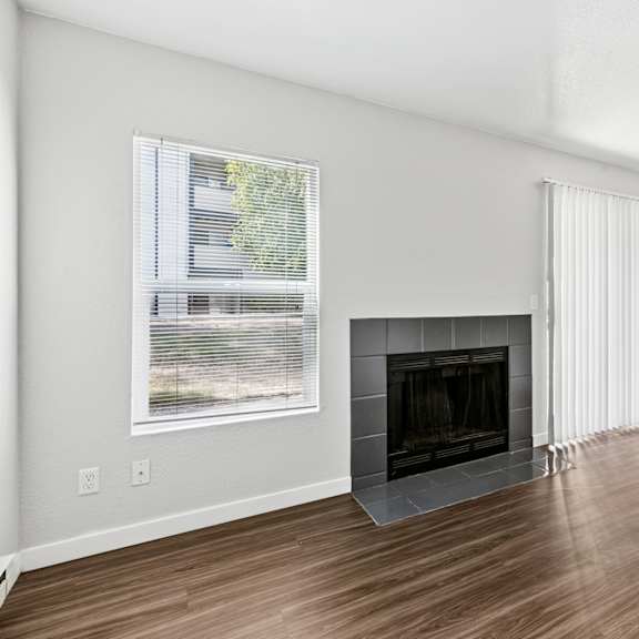 Nickel Creek Apartments in Lynnwood WA living room with a fireplace and sliding glass doors