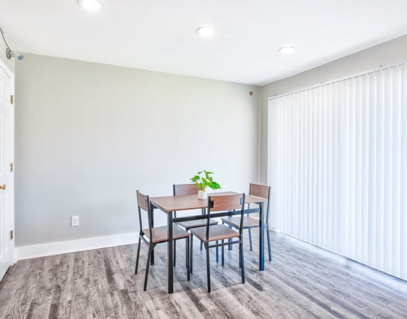 a dining room with a wooden table and chairs at Uphill Flats, Georgia