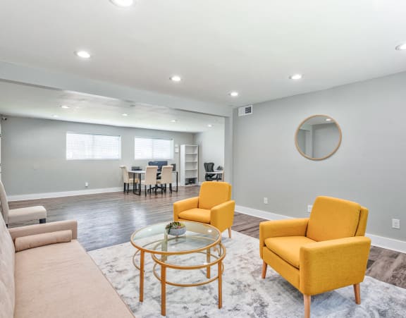 a living room with couches and chairs and a glass table at Uphill Flats, Decatur, GA, 30032
