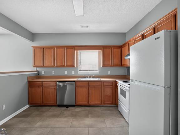 A kitchen with wooden cabinets and a white refrigerator.