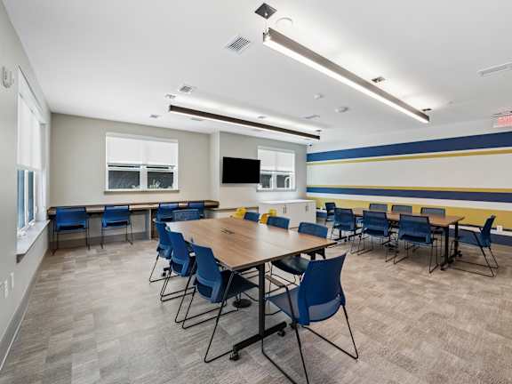 A conference room with a long table and chairs.