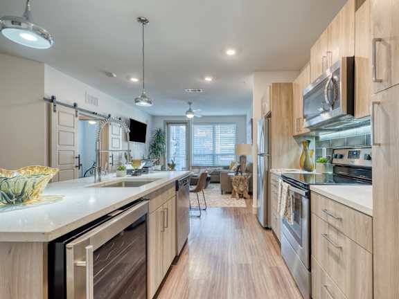 A modern kitchen with a bar area and seating.