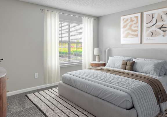 A room with a window and a carpeted floor.