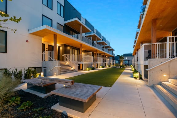 an apartment building with a lot of stairs and green grass