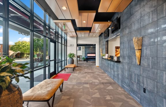 a lobby with a seating area and a large window