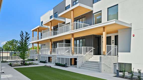 a modern home with a lawn in front of it