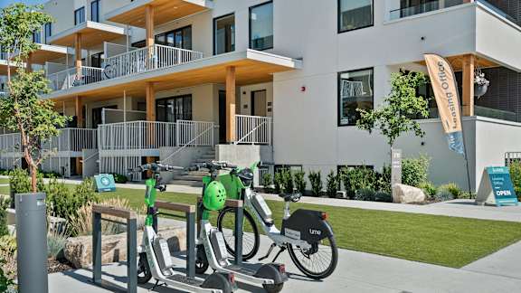 a couple of bikes parked in front of a building