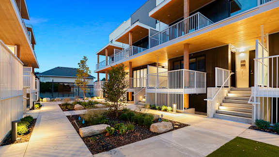 a courtyard is lit up at night