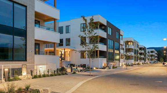 a row of modern apartment buildings on a city street