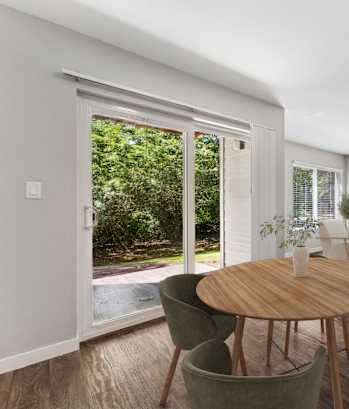 A dining room with a table and chairs.