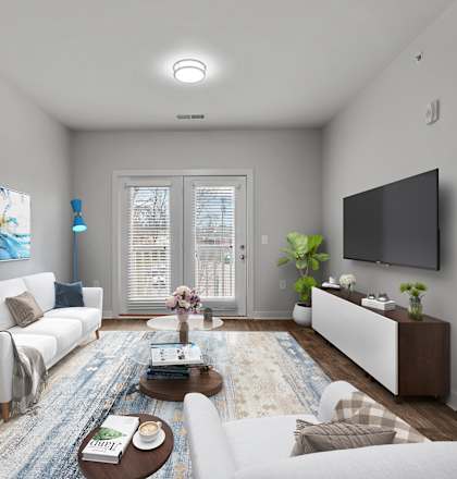 A modern living room with a white sofa, a coffee table, and a painting on the wall.