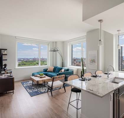 an open living room with a kitchen and a view of the city