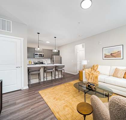 A living room with a white couch and a coffee table.