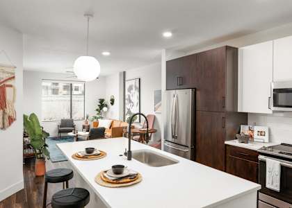 Trovita Rio Apartments in Tempe, Arizona Model Kitchen with Island and Living Room