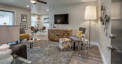a living room with furniture and a ceiling fan