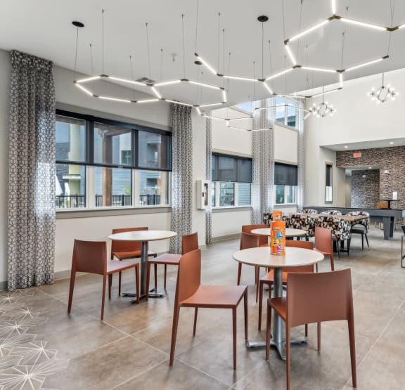 a dining room with tables and chairs and a large window at The Virginia, Seguin, 78155